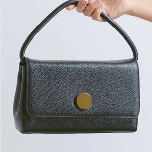 Black leather shoulder bag with silver accent. Little Liffner.